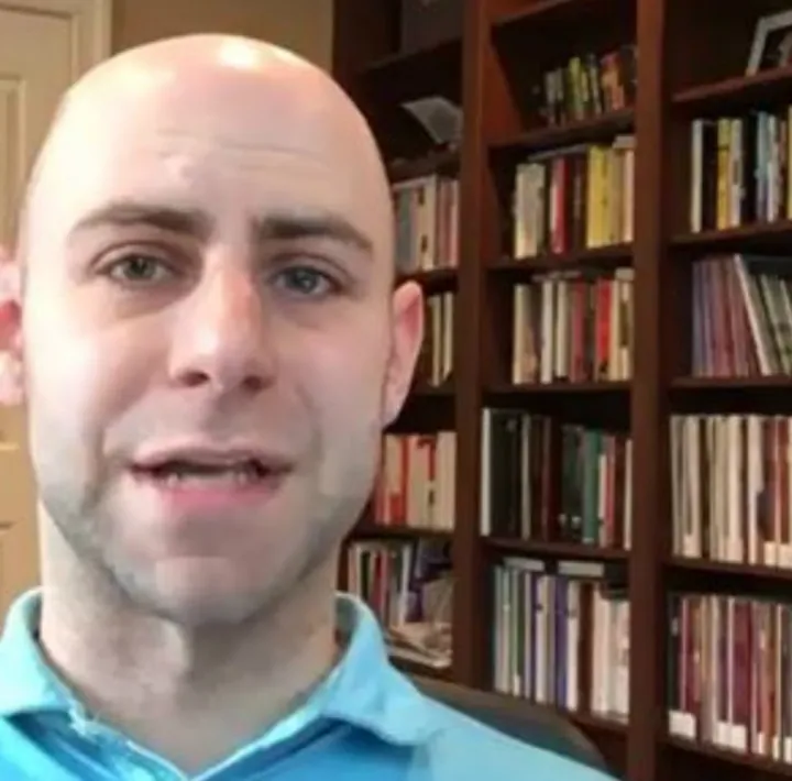 Adam Grant video post: a bald man in a blue polo shirt talking to camera in front of a bookcase.