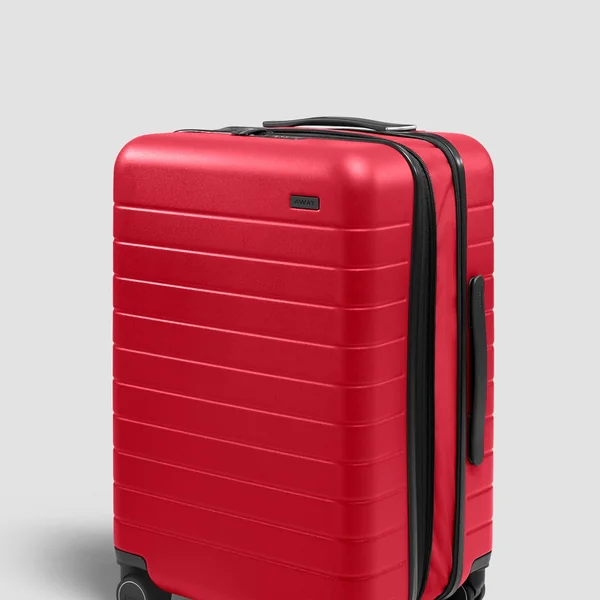 Away short-form post: a bright red hardshell carry-on suitcase with ribbed lines on a light grey background.