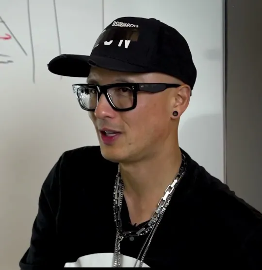 Chris Do short-form post: a man in a black cap and glasses talking in front of a whiteboard.