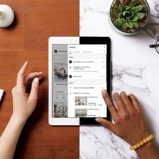 Compass short-form post: hands scrolling a tablet beside a coffee cup, glasses and a plant on a marble desk.