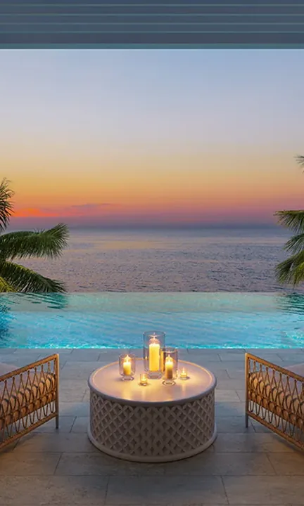 Corcoran short-form post: an infinity pool and a candle-lit table with palm leaves at sunset.