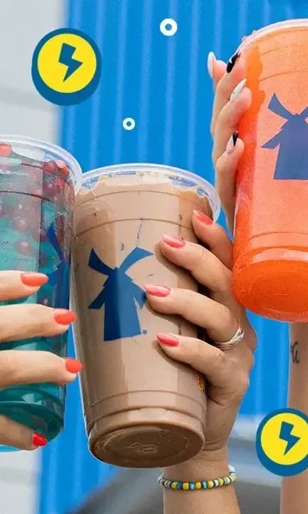 Dutch Bros short-form post: three hands clinking iced drinks in teal, brown and orange against a blue background.