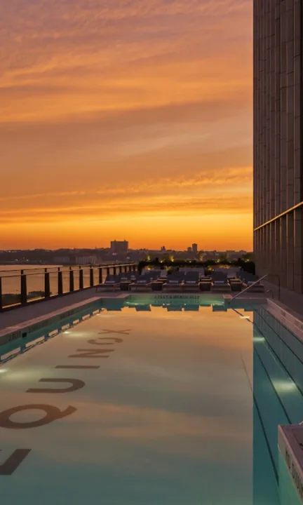Equinox short-form post: a rooftop pool at sunset with the Equinox name on the pool floor.