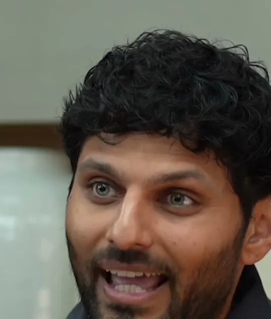 Jay Shetty short-form post: a man with dark curly hair talking in an interview chair, mid-sentence.