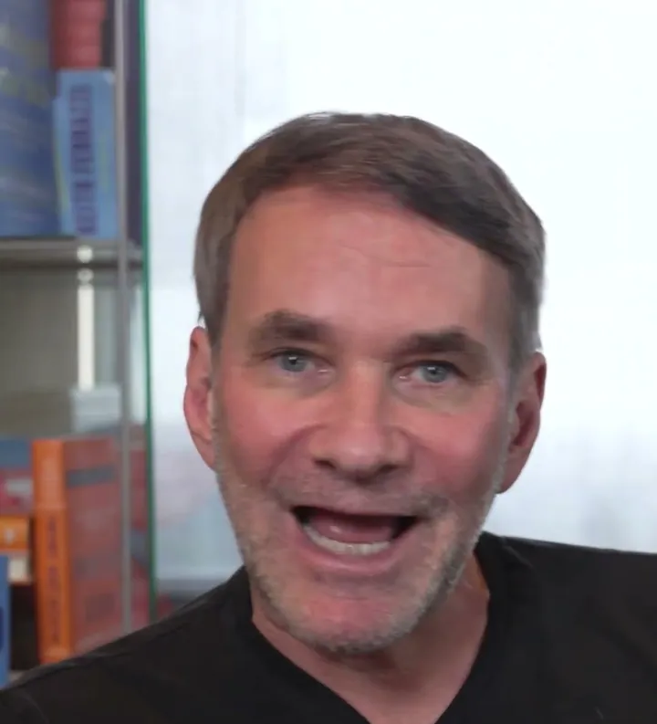 Keith Ferrazzi short-form post: a smiling man in a black t-shirt talking to camera against a plain wall.