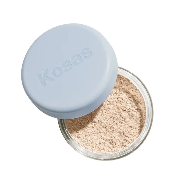 Kosas short-form post: an open jar of Cloud Set Loose Powder with its pale blue lid tilted beside it on a white background.
