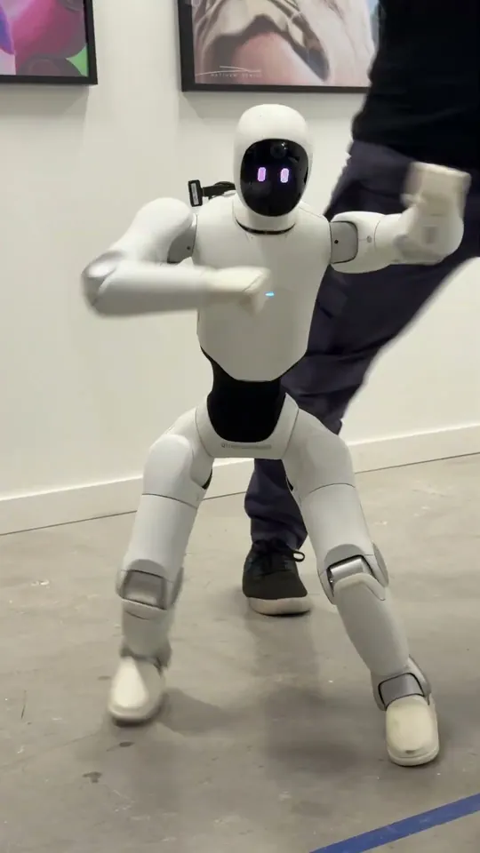 Linus Tech Tips short-form post: a white humanoid robot standing in a studio.