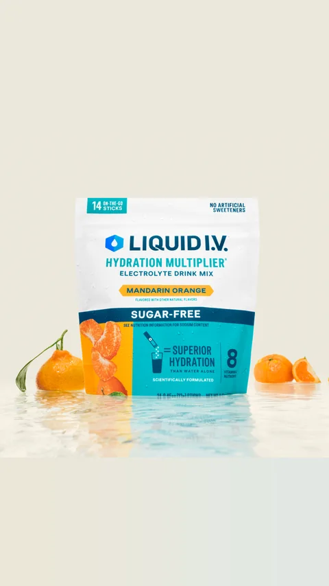 Liquid I.V. short-form post: a pouch of Mandarin Orange Hydration Multiplier standing in shallow water with fresh mandarins around it.