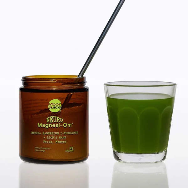 Moon Juice short-form post: an amber Neuro Magnesi-Om jar next to a glass of green drink with a black straw on a white background.