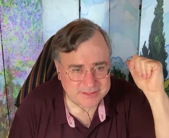 Reid Hoffman short-form post: a man with grey hair in a maroon sweater gesturing on a video call.
