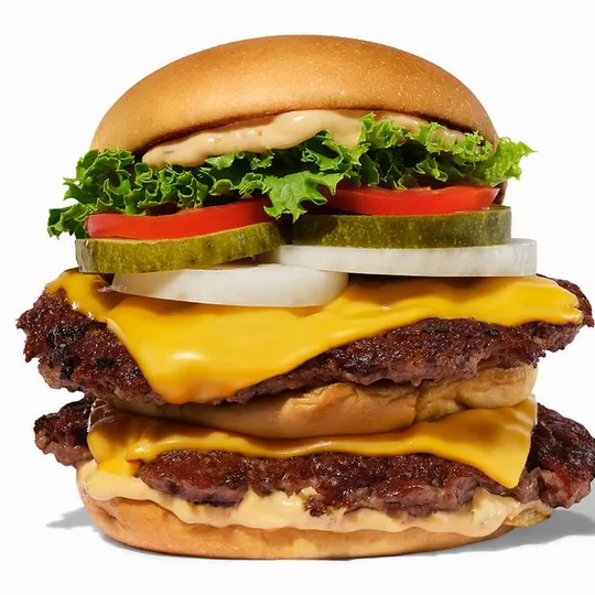 Shake Shack short-form post: a double cheeseburger with lettuce, tomato and pickles on a soft white background.