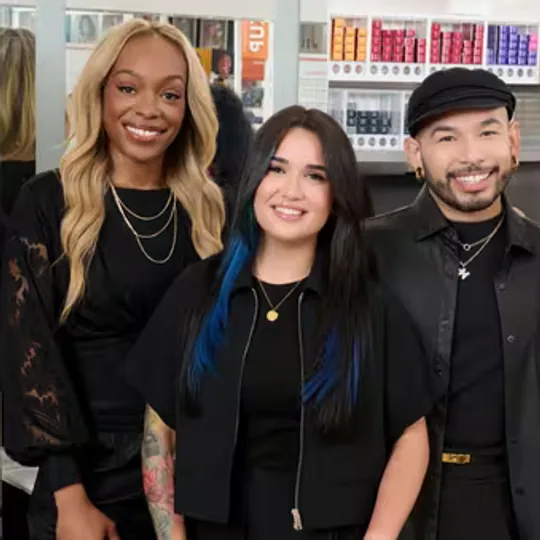 The Salon at Ulta Beauty short-form post: three stylists in black smiling together in front of a wall of hair products.